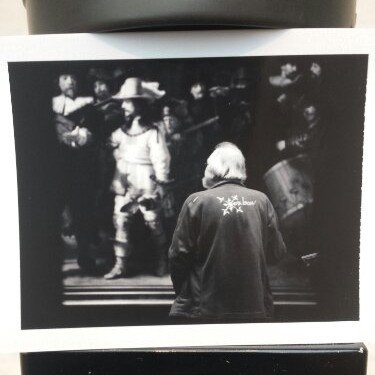 A man viewing Rembrandt's Night Watch painting in the Rijksmusuem Amsterdam